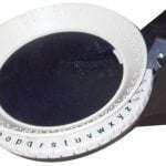 Image showing a close-up view of a Braille label maker showing the print letter with the corresponding Braille characters.