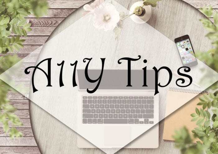 Bistro table with laptop, cell phone, notepad, pen and flower with the words "A11Y Tips"