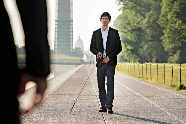Auggie Anderson walking down waterfront sidewalk with his white-cane during an episode of Covert Affairs Auggie Anderson walking down waterfront sidewalk with his white-cane during an episode of Covert Affairs