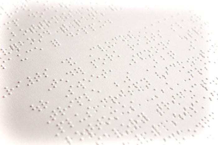 Image showing a close-up view of a Braille Document by Braille Works with faded borders.