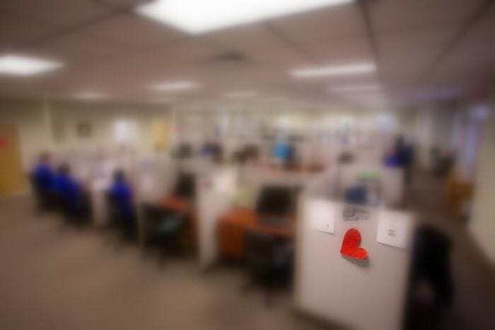 A blurry image showing several Braille Works employees working at their desks. The blurry effect is being used to demonstrate a visual impairment. A blurry image showing several Braille Works employees working at their desks. The blurry effect is being used to demonstrate a visual impairment.