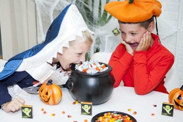 Image showing two young boys in Halloween costumes snacking on candy. Image showing two young boys in Halloween costumes snacking on candy.