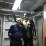 Image showing Lou Fioritto posing next to the Ronald Reagan statue on the USS Reagan in 2012