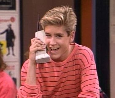 Image showing Zack Morris from the popular 90's TV show "Saved By The Bell" talking on a oversized early model cell phone. Image showing Zack Morris from the popular 90's TV show "Saved By The Bell" talking on a oversized early model cell phone.