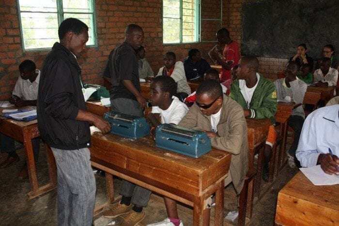 Image showing Eric Niyikiza teaching a braille class at Camp BE in Rwanda