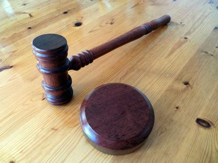 A gavel resting on a wooden table. A gavel resting on a wooden table.