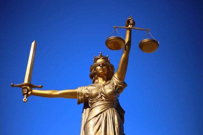 Statue of lady justice holding up her scales and sword